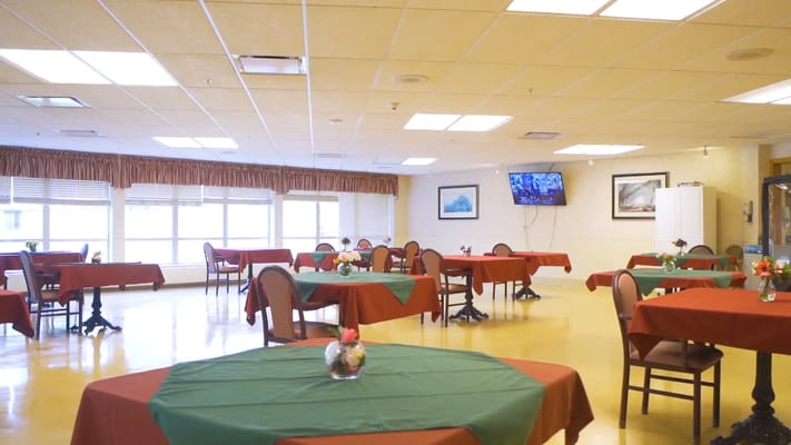 Interior dining room with green and red tablecloths