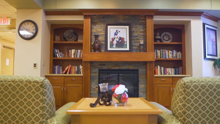 Cozy common area with bookshelves and fireplace