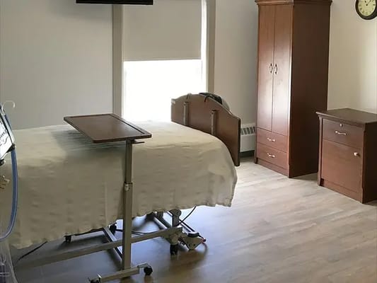 A private resident room with a bed and furniture