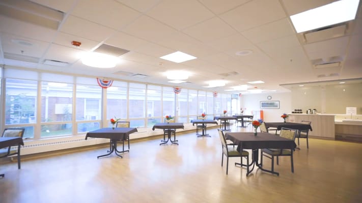 Bright common area with tables and flowers