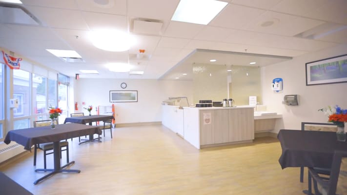 Bright interior dining area with tables and service counter