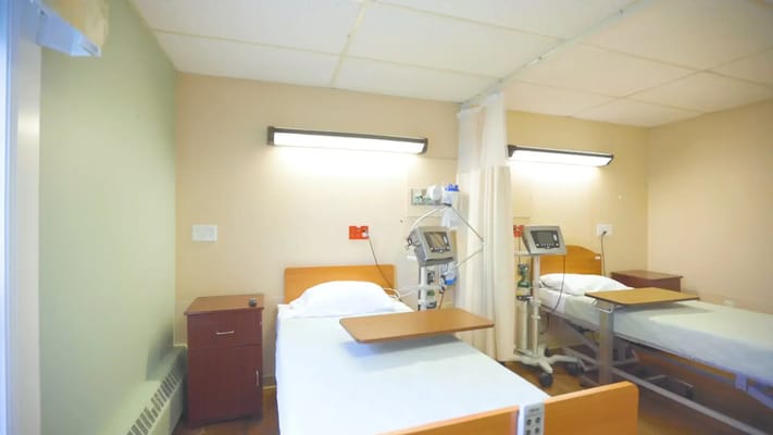 Interior view of a resident room with hospital beds