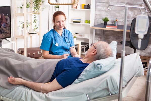 A caregiver attending to a resident in a room