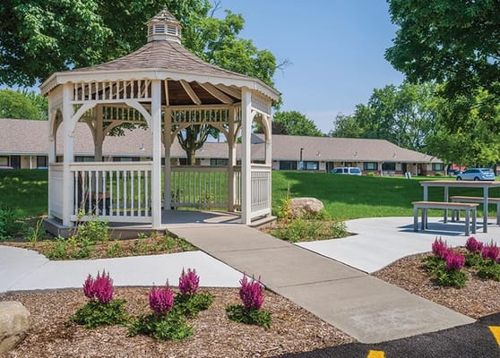 Outdoor gazebo surrounded by landscaped gardens