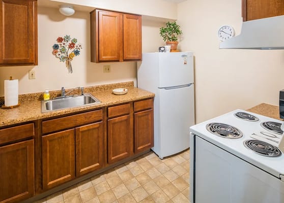 Bright kitchen with wooden cabinets and appliances