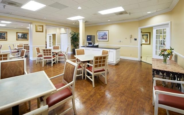 Brightly lit dining area with tables and chairs