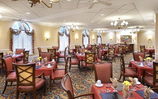 Elegant dining room with red tablecloths and floral centerpieces
