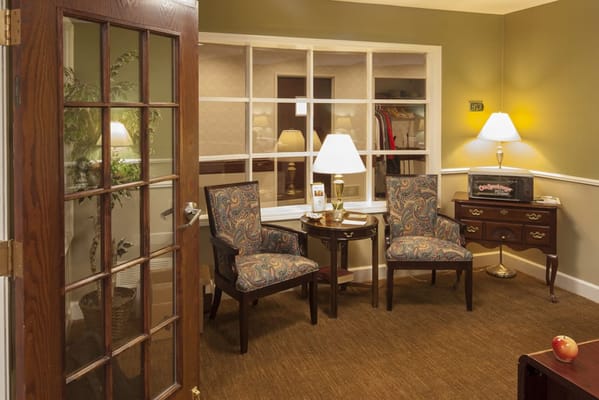 Cozy sitting area with two chairs and lamps