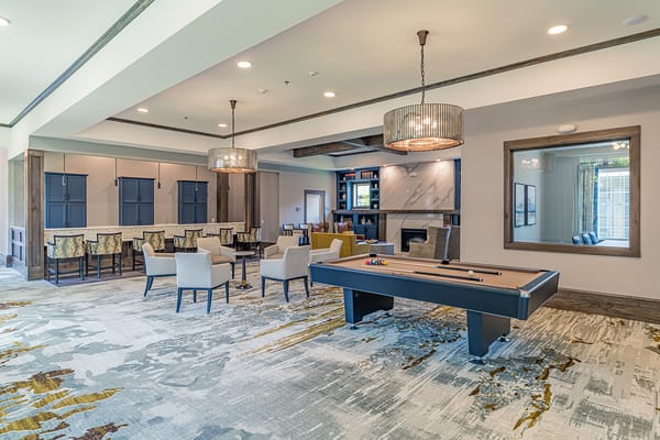 Bright common area with seating and a pool table