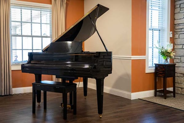 A grand piano in a well-lit common area