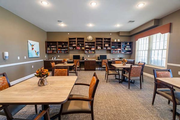 Bright common area with tables and bookshelves