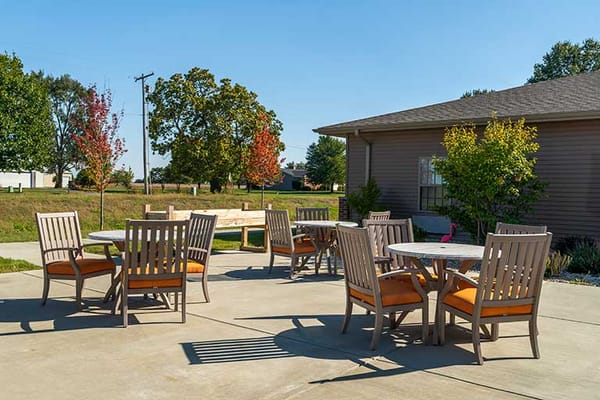 Outdoor seating area with tables and chairs
