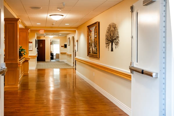A well-lit corridor with artwork and furnishings