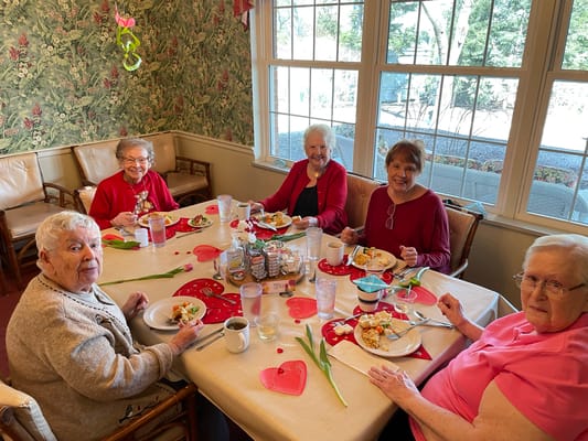 Residents enjoying a meal together at a dining table