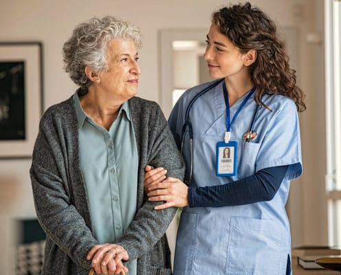 Care staff assisting a resident in a bright room