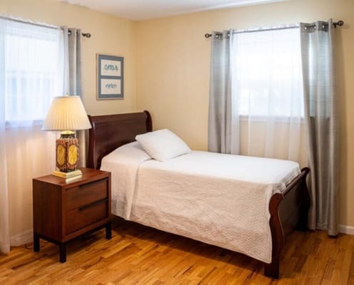 Cozy single bedroom with warm lighting