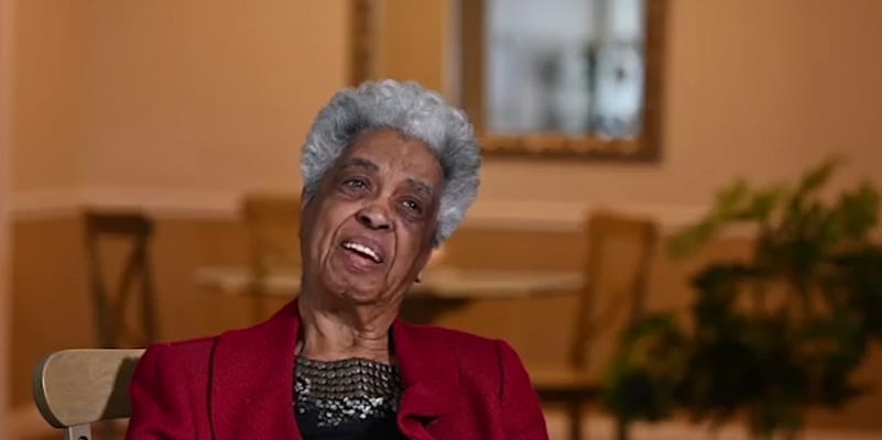 Resident smiling during a conversation in the common area