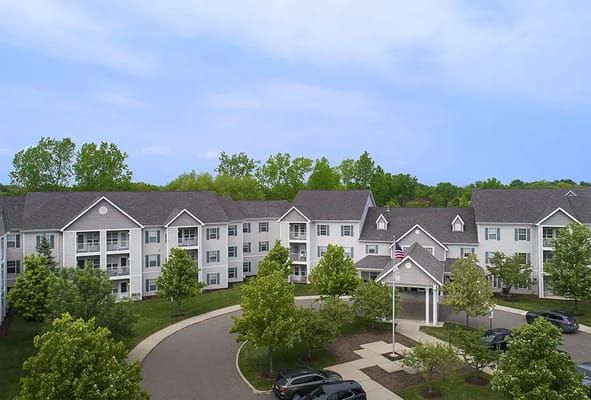 Exterior view of a senior living facility with landscaped areas