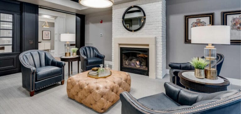 Cozy common area with blue chairs and a fireplace