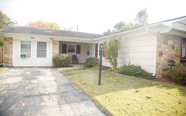 Front view of a senior living facility with gardens