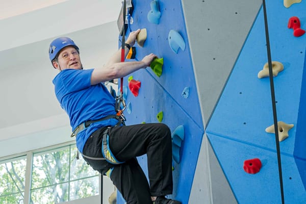 Resident climbing on an indoor rock wall