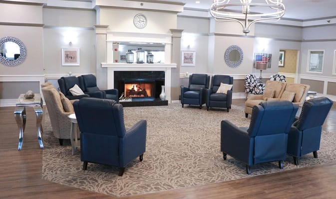 Interior seating area with a fireplace and chairs