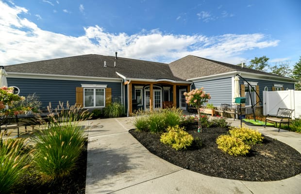 Exterior view of a senior living facility with garden