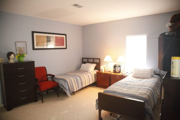 Simple interior room with two beds and basic furniture