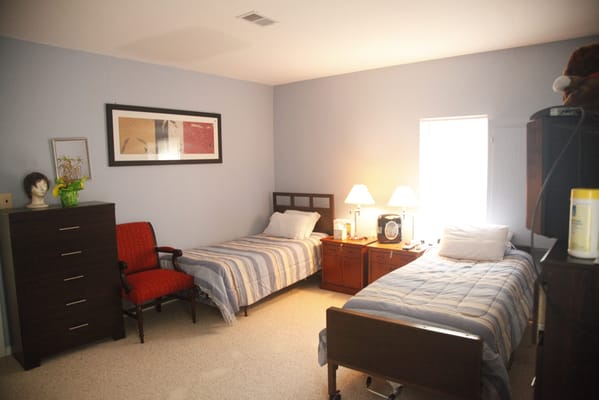 Simple interior room with two beds and basic furniture