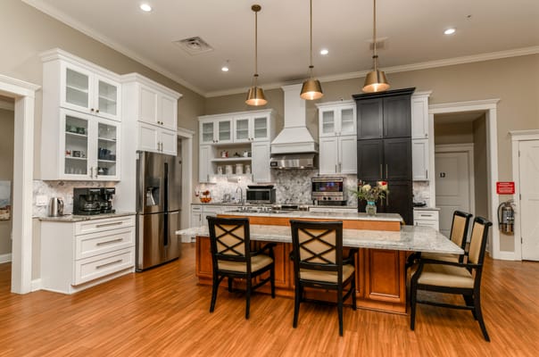 Modern kitchen area with stylish appliances and seating