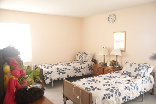 Private resident room with twin beds and cozy decor