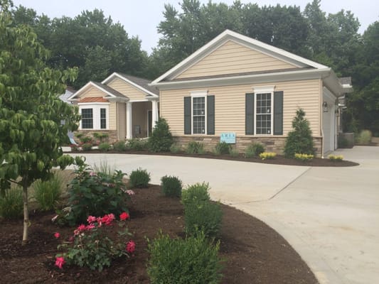 Exterior view of a senior living facility with landscaped garden
