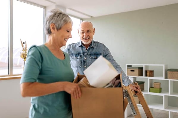 Residents unpacking boxes in a bright interior space