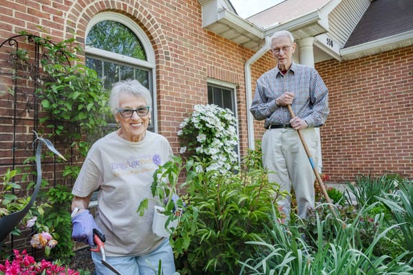 Residents gardening in a sunny outdoor space