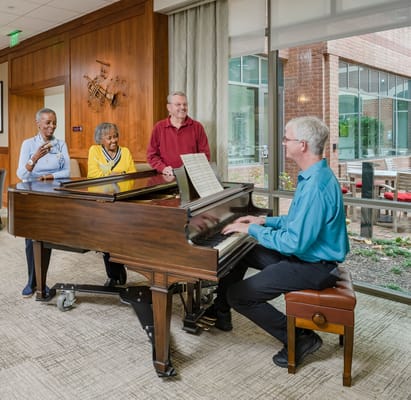 Residents enjoying a music performance in a vibrant common area