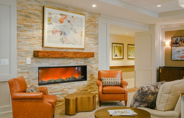 Cozy living area with stone fireplace and seating