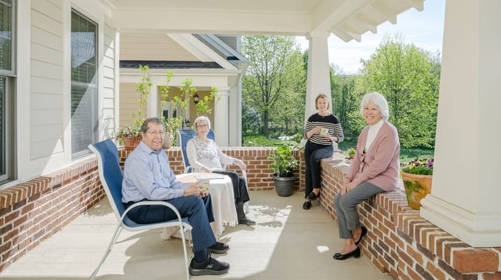 Residents enjoying time on a sunny porch