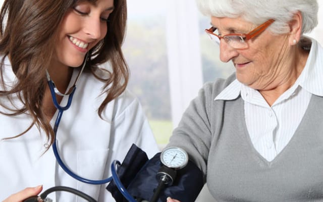 Nurse taking a resident's blood pressure