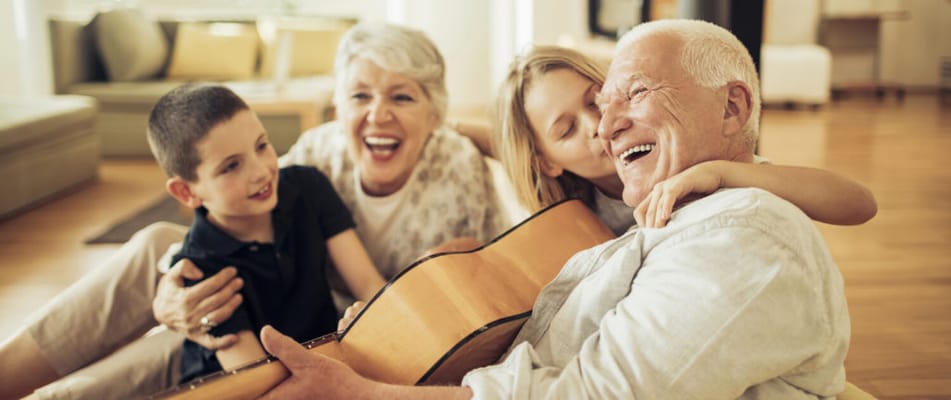 Residents enjoying music and laughter with children