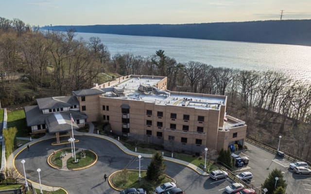 Aerial view of a senior living facility by the river