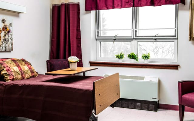 A cozy private resident room with a bed and window