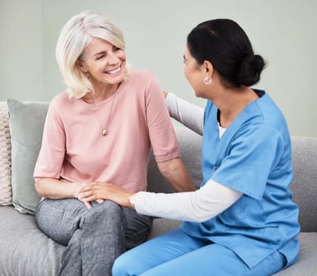 Caregiver and resident enjoying a conversation in a cozy setting