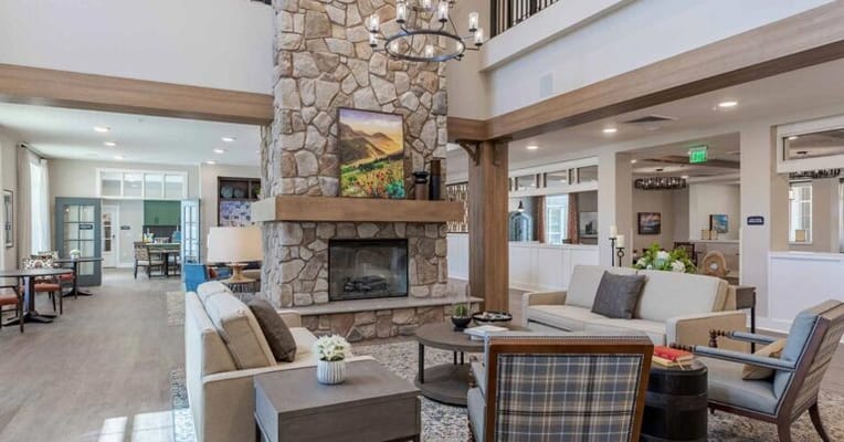 Well-decorated common area with stone fireplace