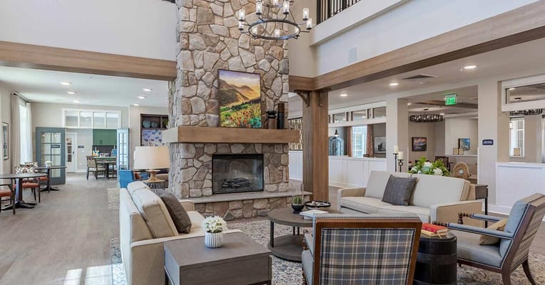 Well-decorated common area with stone fireplace
