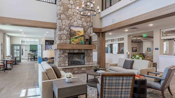 Bright and welcoming common area with a stone fireplace