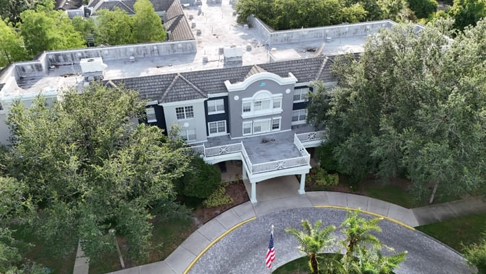 Aerial view of Tampa Gardens Senior Living facility surrounded by greenery.