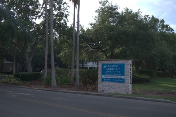 Sign for Tampa Gardens Senior Living at entrance