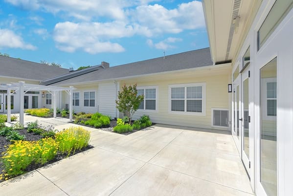 Sunny outdoor patio with landscaped garden at Silverado Frederick