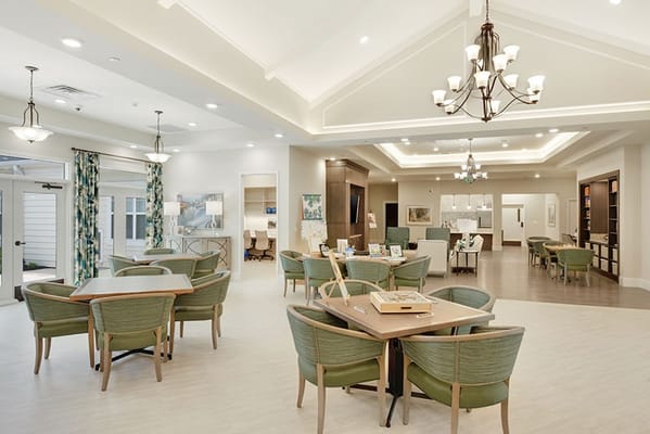 Open living room area with dining tables at Silverado Frederick