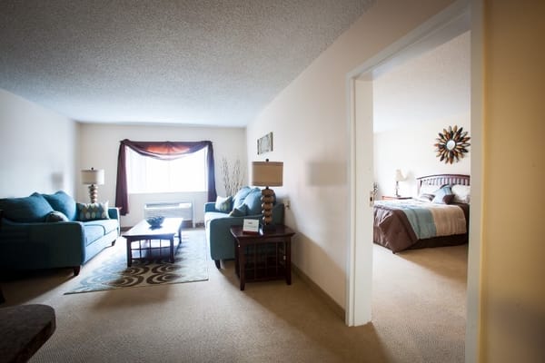 Cozy interior living space with seating and bedroom view